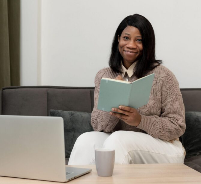 woman-holding-notebook-while-working